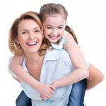 Closeup portrait of happy mother and young daughter Closeup portrait of happy mother and young daughter