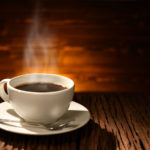 Cup of coffee with smoke on old wooden background Cup of coffee with smoke on old wooden background